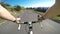 Point of view. Male road cyclist riding his bicycle downhill on a asphalt road on a sunny day