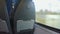 Point of view of passenger traveling by train, looking outside through window