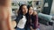 Point of view shot of attractive young ladies African American and Asian taking selfie at home posing for camera then