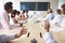 Point Of View Shot Of Businesspeople Around Boardroom Table