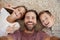 Point Of View Shot Of Father And Children Posing For Selfie