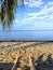 A point of view shot with the legs and feet of a man showing lying on a beautiful sandy beach overlooking vast calm atlantic ocean