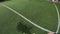 Point of view of soccer player training his skills at football field at evening time. Man practicing dribbling the ball