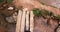 Point of view of someones feet walking on small stone bridge