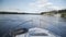 Point of view speedboat floating on river on background of blue sky with clouds. Driving motorboat on blue river near