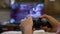 Point of view of teenage gamer holding controller to play captivated by video games on digital TV screen -