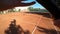Point of view of tennis player running and serving on field