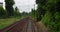 Point of view train travel under cloudy sky