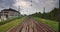 Point of view train travel under cloudy sky