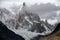 Pointed top with glacier in clouds.