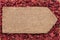 Pointer of burlap lying on a dry cranberry background