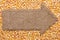 Pointer of burlap with place for your text, lying on a corn