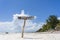 Pointer pizza on a wooden post on the tropical sand beach of Zanzibar island, Tanzania, Africa. Travel and vacation concept