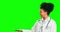 Pointing, doctor and choice with woman on green screen for offer, promotion and medicine. Healthcare, medical and idea