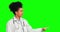 Pointing, doctor and confused with woman on green screen for offer, promotion and medicine. Healthcare, medical and