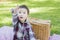 Pointing Mixed Race Toddler Sitting in Park Near Picnic Basket