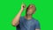 Pointing young bald man on green background