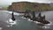 Pointy rocks sticking out of the ocean at Reynisfjara Beach near Vik in Iceland