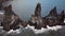 Pointy rocks sticking out of the ocean at Reynisfjara Beach near Vik in Iceland