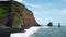 Pointy rocks sticking out of the ocean at Reynisfjara Beach near Vik in Iceland