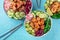 Poke bowl variety, a close-up with chopsticks on a blue background