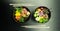 Poke salads with tuna and beef in bowls on the table. Two bowls of poke salad with chopsticks on a gray background