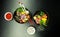 Poke salads with tuna and beef in bowls on the table. Two bowls of poke salad with chopsticks on a gray background