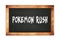 POKEMON  RUSH text written on wooden frame school blackboard