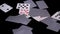 Poker cards fly and fall on a black surface