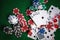 Poker chips and cards on casino gamble green table with royal fl