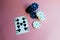 Poker chips and cards on a pink background. The game of poker. Chip dealer.