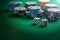Poker chips piles and dice on green felt background, copy space