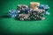 Poker chips piles on green felt background, copy space