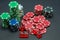 Poker chips stacked on black background and 5 red dice