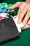 Poker player cheats with card from the sleeve