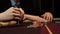 Poker player showing good card combination, ace and king on poker table. Man`s hand close-up. Casino gamble.