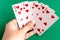 Poker straight flush playing card in womanâ€™s hand