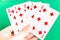 Poker straight flush playing card in womanâ€™s hand