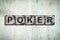 Poker, word on stone blocks, on a gray concrete wall. Poker. Gambling.