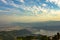 Pokhara city under a blue sky with white clouds in a misty mountain valley at Lake Phewa aerial view