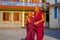 POKHARA, NEPAL - OCTOBER 06 2017: Unidentified Buddhist monk boys hugging each other, little boy doing a success sign