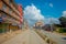 POKHARA, NEPAL OCTOBER 10, 2017: Outdoor view of asphalted road with some motorbikes, cars parked around in the street