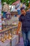 POKHARA, NEPAL OCTOBER 10, 2017: Unidentified businessman wearing a black t-shirt and touching the bells of different