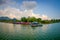 POKHARA, NEPAL - SEPTEMBER 04, 2017: Beautiful landscape of some buildings in the lakeshore with some boats in the Phewa