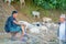 POKHARA, NEPAL, SEPTEMBER 04, 2017: Shepherds take care of flocks of goats, going along the street of small town in