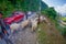 POKHARA, NEPAL, SEPTEMBER 04, 2017: Shepherds take care of flocks of goats, going along the street with some cars parked