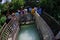 Pokhara, Nepal - September 12, 2017: Unidenfied people walking over the hanging long metal bridge over the Seti river