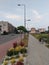 Poland - July 1 2021: Town with brick stone pavement with buildings, colorful plants and a bench