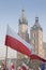 Poland, Krakow, Polish Flags and Towers of St Mary Church