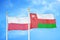 Poland and Oman two flags on flagpoles and blue cloudy sky